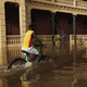 Riding a bicycle in flooded Grand Bassam